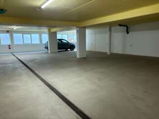 Discover this spacious and well-lit parking garage, perfect for secure vehicle storage.