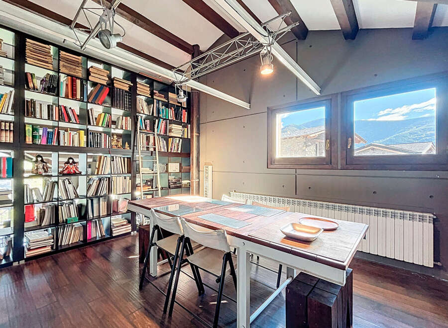 This stunning property boasts a unique library with floor-to-ceiling bookshelves, perfect for book lovers.