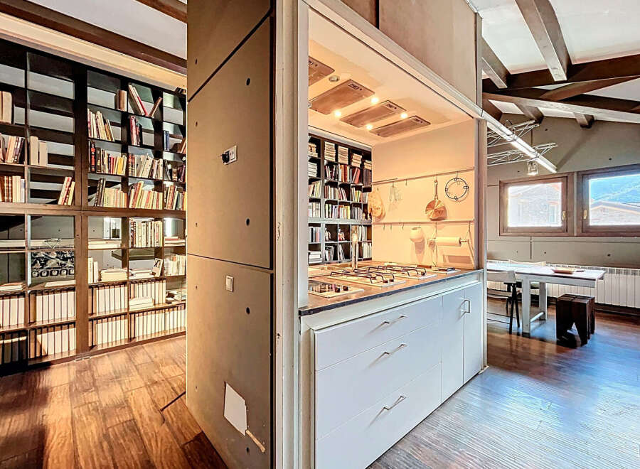 Discover a unique property featuring a stunning kitchen seamlessly integrated with a library.
