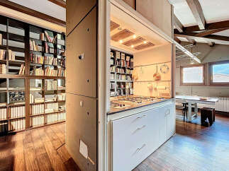 Discover a unique property featuring a stunning kitchen seamlessly integrated with a library.