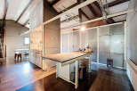 This stunning property boasts a modern, open-concept kitchen with sleek concrete accents and a spacious island.