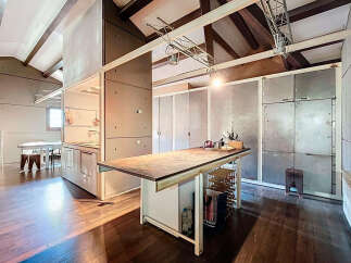 This stunning property boasts a modern, open-concept kitchen with sleek concrete accents and a spacious island.