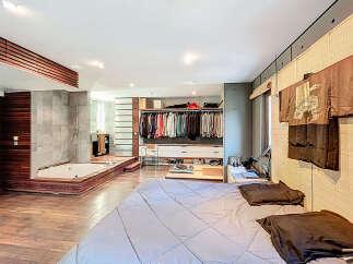 Step into luxury with this stunning bedroom featuring a spa-like bathroom and a spacious walk-in closet.