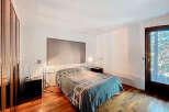 Discover the elegance of this bedroom, featuring a sleek design and modern aesthetic.