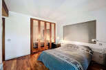This stunning bedroom boasts a modern design with a touch of elegance.