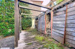 Discover the charm of this unique property, featuring a rustic wooden structure and a serene outdoor space.