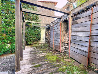 Discover the charm of this unique property, featuring a rustic wooden structure and a serene outdoor space.