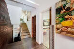 Step into luxury with this stunning property featuring a grand staircase and exquisite wooden accents.