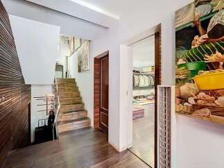 Step into luxury with this stunning property featuring a grand staircase and exquisite wooden accents.