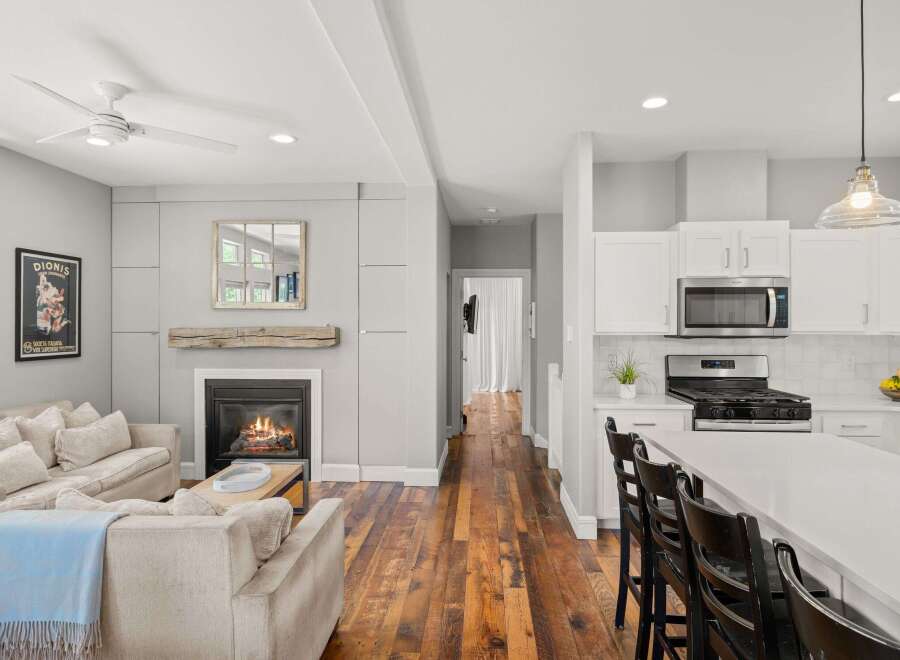 This stunning property boasts a cozy living room with a fireplace, perfect for relaxing evenings.