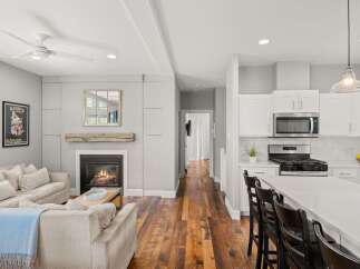 This stunning property boasts a cozy living room with a fireplace, perfect for relaxing evenings.