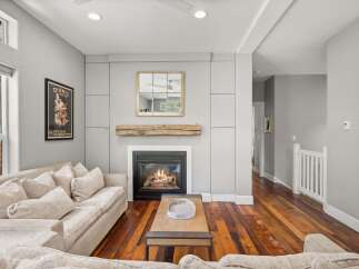 This stunning living room boasts a cozy fireplace, perfect for chilly evenings.