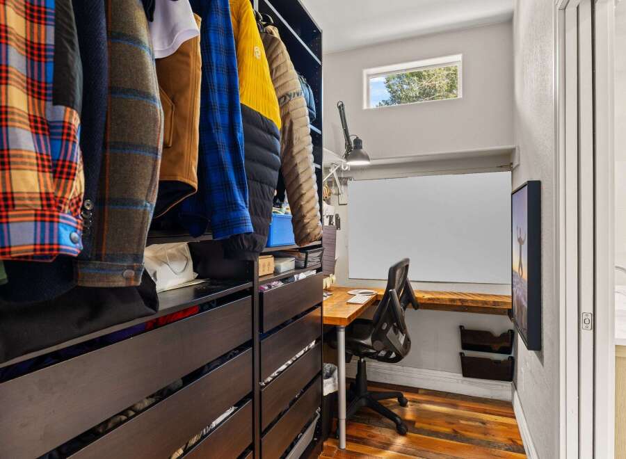 Step into this stylish home office, complete with a built-in desk and ample storage.
