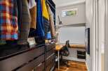 Step into this stylish home office, complete with a built-in desk and ample storage.