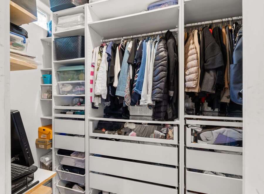 This well-organized closet offers ample storage space for all your belongings.