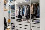 This well-organized closet offers ample storage space for all your belongings.