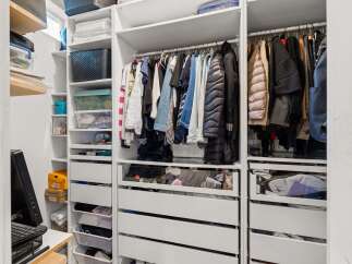 This well-organized closet offers ample storage space for all your belongings.