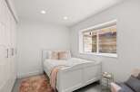 This charming bedroom features a cozy bed with plush pillows and a soft rug, creating a warm and inviting atmosphere.