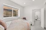 This cozy bedroom features a comfortable bed with soft bedding and a plush throw, perfect for relaxation.