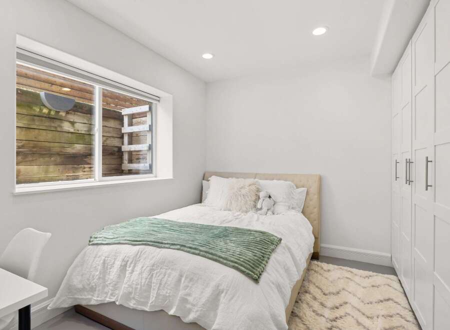 This cozy bedroom offers a serene retreat with its neutral color palette and inviting ambiance.