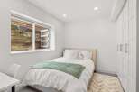 This cozy bedroom offers a serene retreat with its neutral color palette and inviting ambiance.