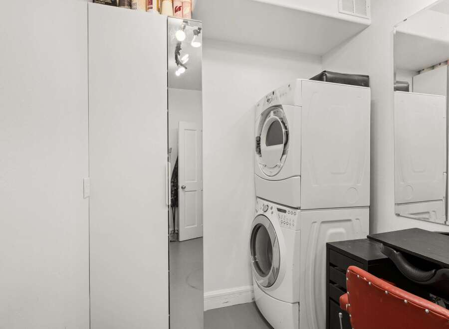 This property features a convenient laundry area with a stacked washer and dryer, perfect for modern living.