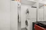 This property features a convenient laundry area with a stacked washer and dryer, perfect for modern living.