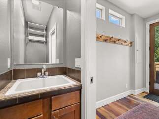 This charming property features a well-appointed bathroom with a stylish sink and ample storage.
