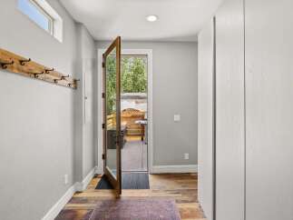 Step into this inviting entryway, showcasing a blend of rustic charm and modern design.