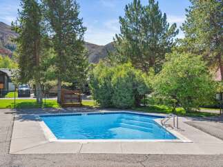 Enjoy the refreshing pool on a sunny day! This property features a beautiful outdoor pool, perfect for relaxation and recreation.