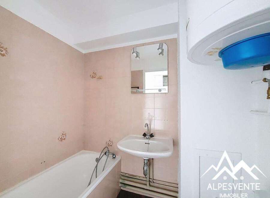 Discover this charming bathroom featuring a bathtub and a sink, perfect for your daily routines.