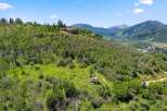 Nestled on a lush hillside, this stunning property offers breathtaking views of the surrounding mountains and valley.