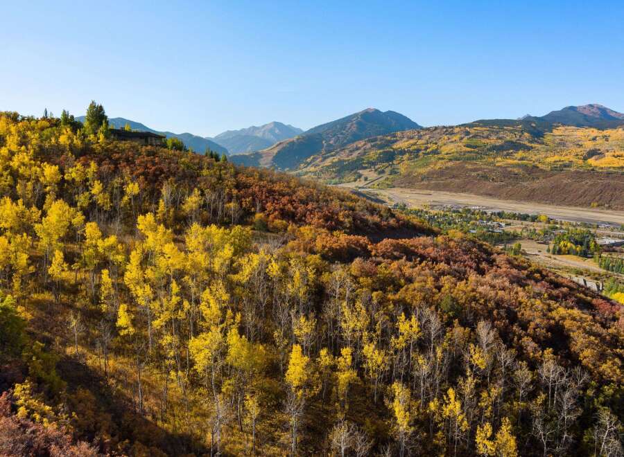 Nestled amidst the vibrant hues of autumn, this property offers a stunning view of the surrounding mountains and valleys.