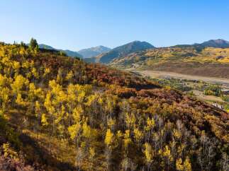 Nestled amidst the vibrant hues of autumn, this property offers a stunning view of the surrounding mountains and valleys.