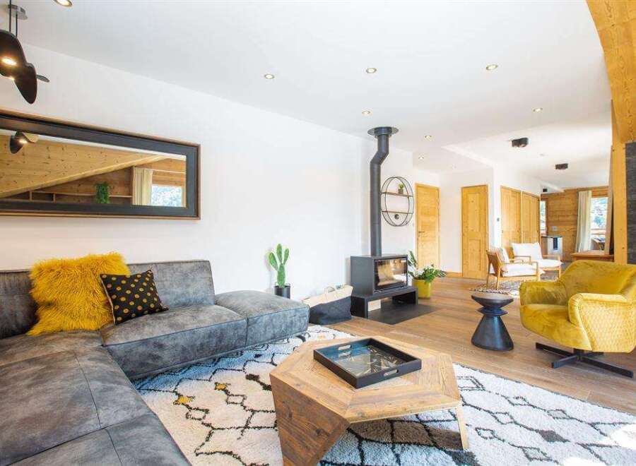 Step into luxury with this stunning living space! Featuring a modern fireplace, a stylish sectional sofa, and a cozy yellow armchair, this home is designed for comfort and elegance.