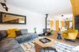 Step into luxury with this stunning living space! Featuring a modern fireplace, a stylish sectional sofa, and a cozy yellow armchair, this home is designed for comfort and elegance.