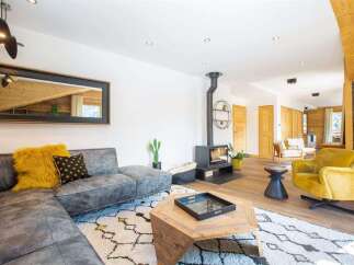 Step into luxury with this stunning living space! Featuring a modern fireplace, a stylish sectional sofa, and a cozy yellow armchair, this home is designed for comfort and elegance.