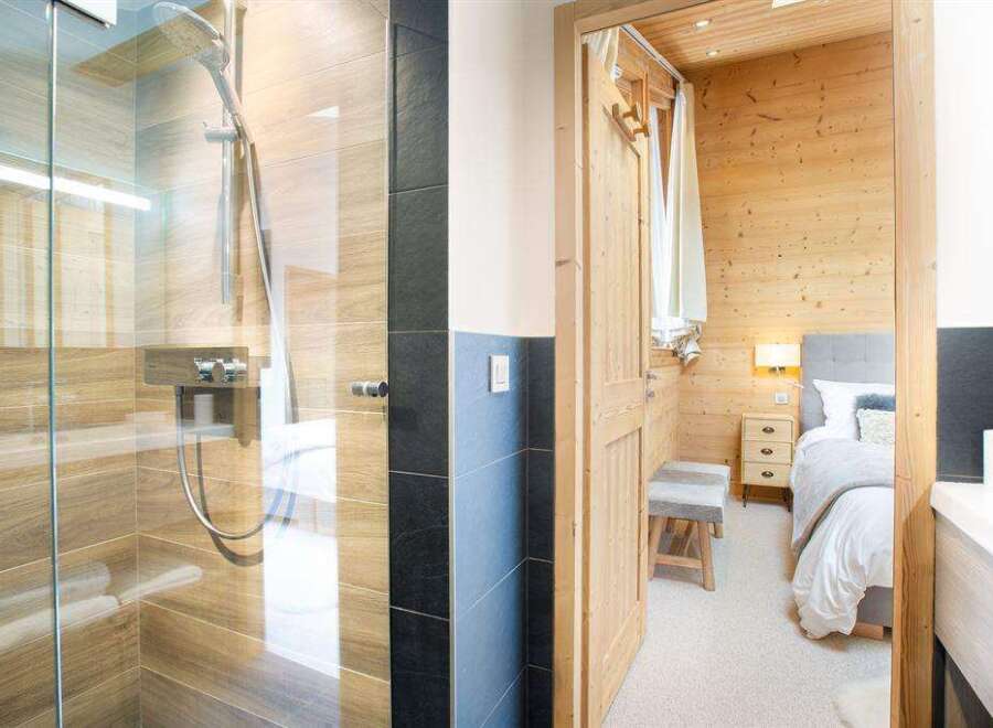 Step into luxury with this stunning property featuring a modern shower and a cozy bedroom.