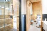 Step into luxury with this stunning property featuring a modern shower and a cozy bedroom.