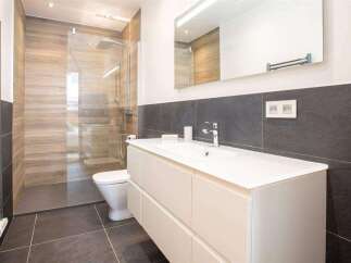 Step into modern luxury with this stunning bathroom! Featuring a sleek vanity, a spacious walk-in shower, and elegant tile work, this space is designed for both style and functionality.