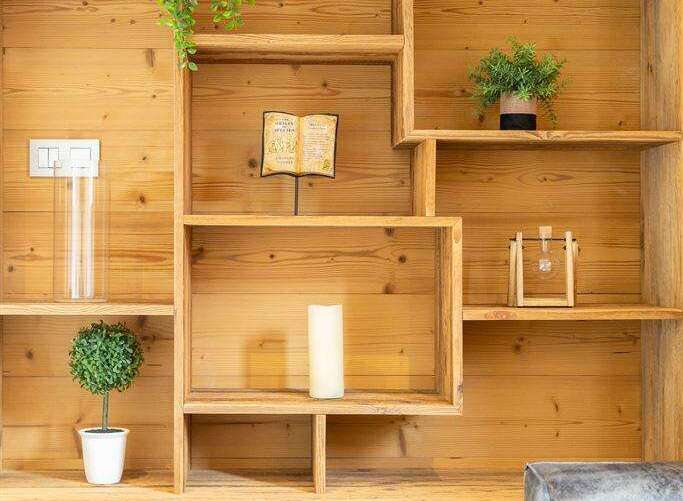This stunning property boasts a custom-built wooden shelving unit, perfect for displaying decor and adding character.