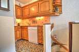 Discover the charm of this cozy kitchen, featuring classic wooden cabinetry and a convenient dishwasher.