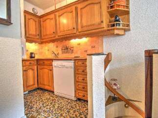 Discover the charm of this cozy kitchen, featuring classic wooden cabinetry and a convenient dishwasher.