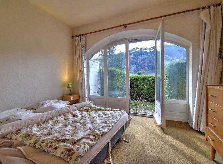 This charming bedroom offers a serene retreat with stunning views.