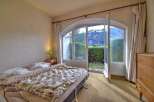 This charming bedroom offers a serene retreat with stunning views.