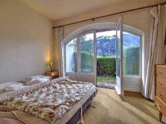This charming bedroom offers a serene retreat with stunning views.