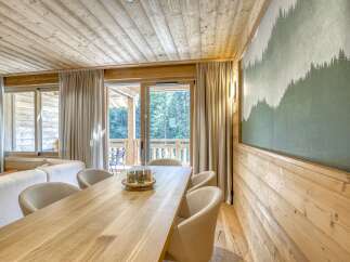 This stunning property boasts a warm and inviting interior, featuring beautiful wooden accents throughout.