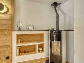This stunning property boasts a modern interior with a cozy fireplace, perfect for those chilly evenings.