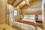 This cozy bedroom features a rustic wooden interior, creating a warm and inviting atmosphere.