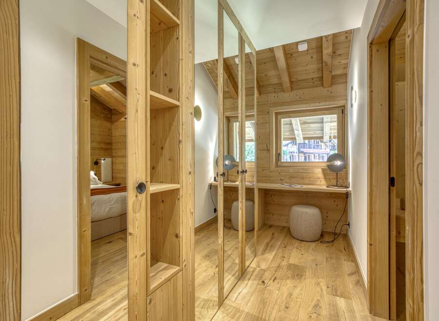 This stunning property boasts a warm and inviting interior with beautiful wooden accents throughout.